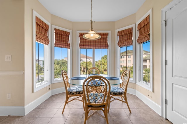 dining space featuring light tile patterned floors and plenty of natural light