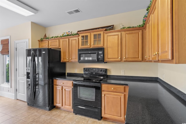 kitchen with light tile patterned flooring and black appliances