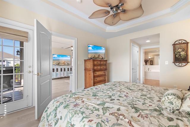 bedroom featuring access to exterior, light wood-type flooring, ornamental molding, a raised ceiling, and ceiling fan