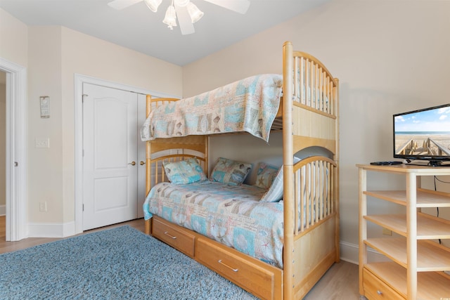 bedroom featuring a closet, light hardwood / wood-style flooring, and ceiling fan