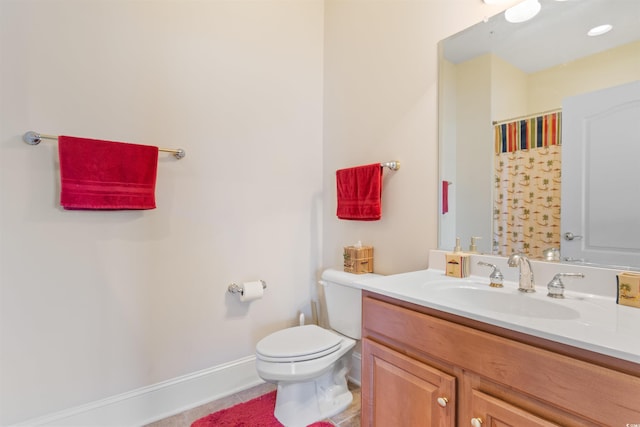 bathroom featuring tile patterned flooring, vanity, and toilet