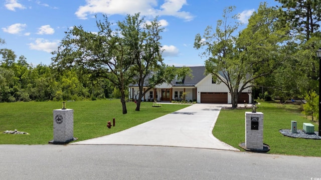 view of front of home with a garage and a front lawn