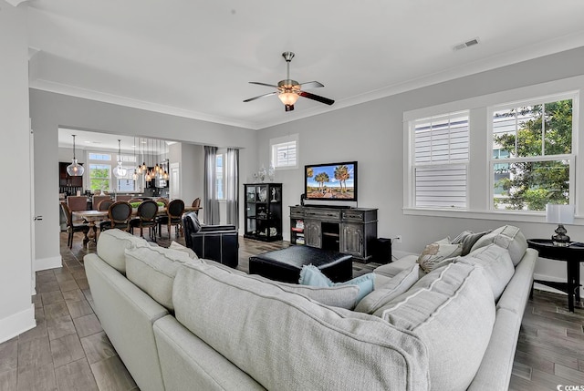 living room with ornamental molding, a healthy amount of sunlight, and wood-type flooring