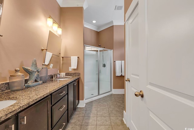 bathroom featuring ornamental molding, tile patterned flooring, vanity, and a shower with shower door