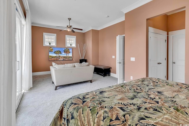 carpeted bedroom featuring ceiling fan and crown molding