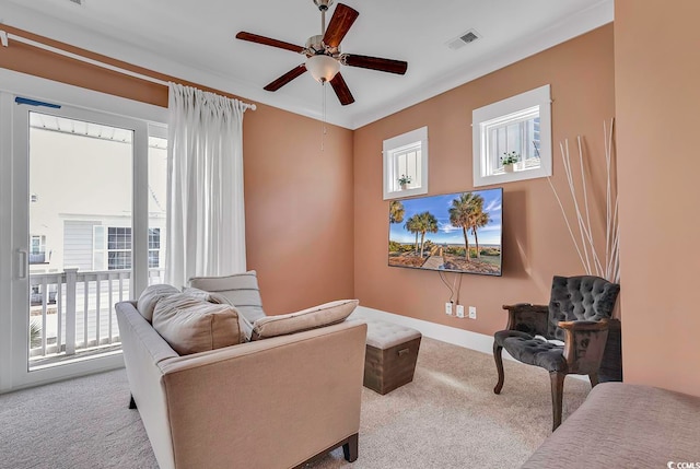 carpeted living room featuring plenty of natural light and ceiling fan