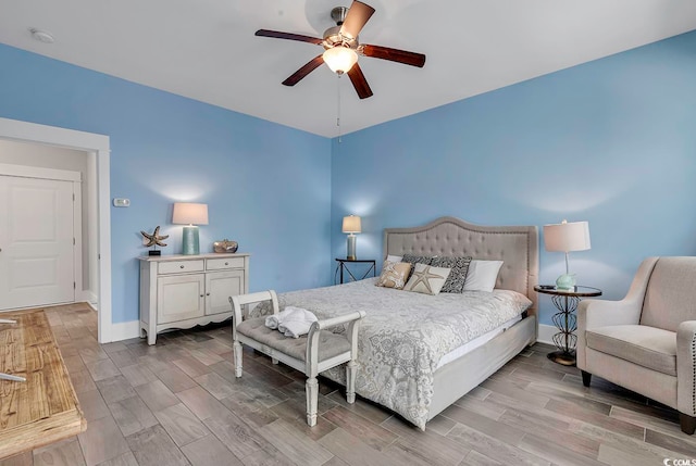 bedroom with ceiling fan and light hardwood / wood-style floors