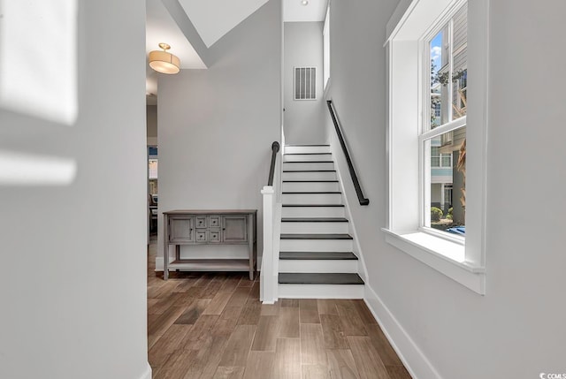 staircase with wood-type flooring