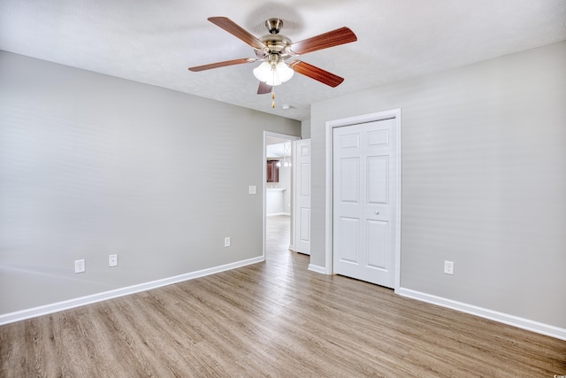 unfurnished bedroom with ceiling fan and light wood-type flooring