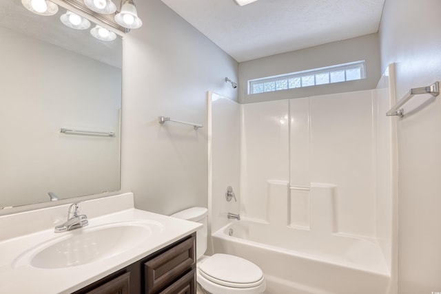 full bathroom with vanity, toilet, washtub / shower combination, and a textured ceiling