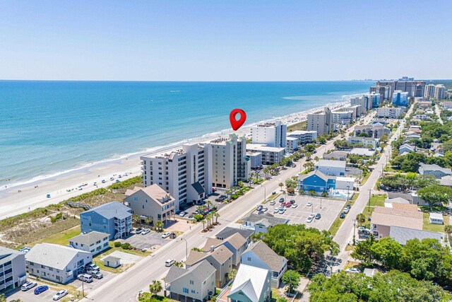 birds eye view of property featuring a beach view and a water view