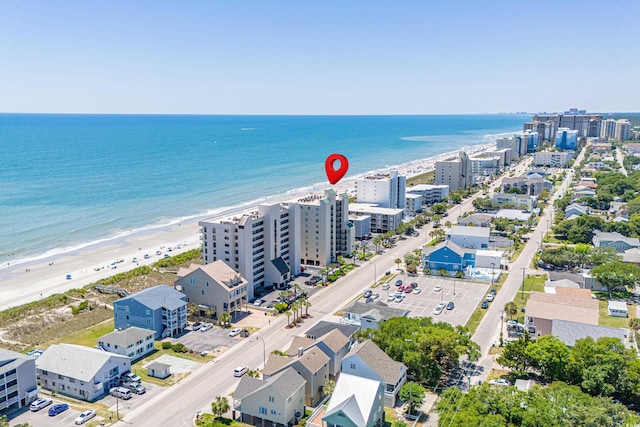 drone / aerial view with a water view and a beach view