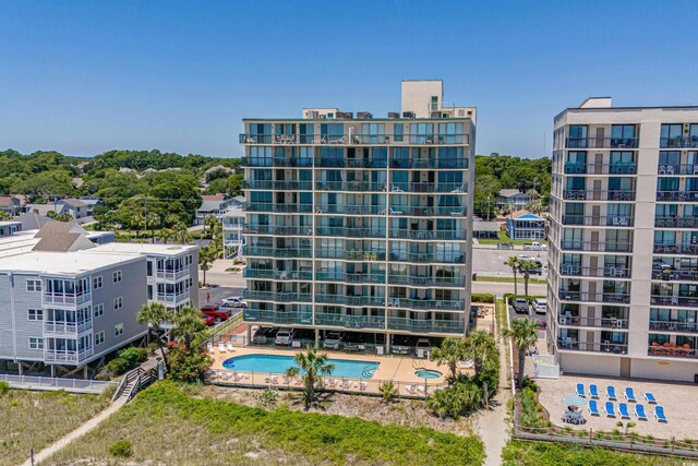 view of building exterior with a community pool