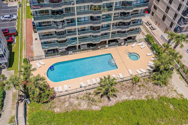 view of swimming pool with a hot tub and a patio area