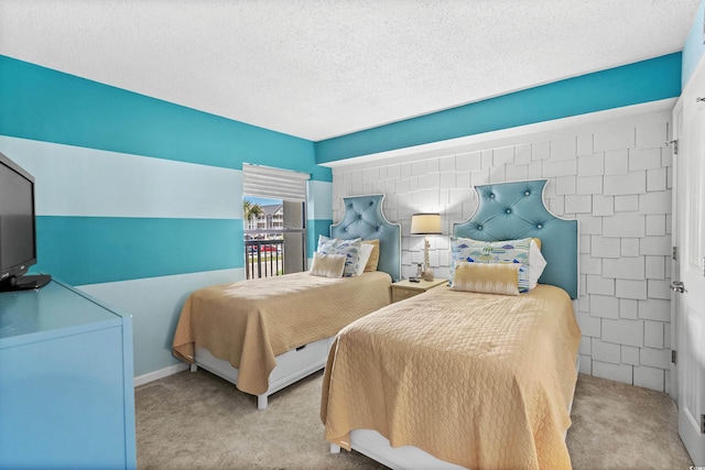 carpeted bedroom featuring a textured ceiling