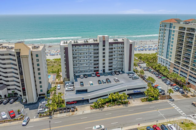 drone / aerial view with a water view and a view of the beach