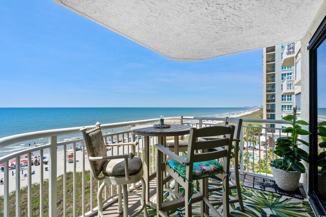 balcony with a view of the beach and a water view