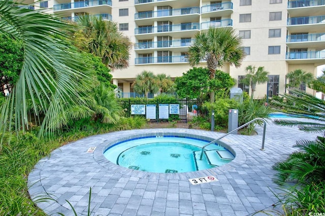 view of pool with a community hot tub