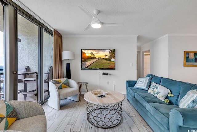 living room with hardwood / wood-style floors, a textured ceiling, ceiling fan, and crown molding