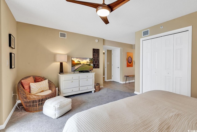 bedroom featuring ceiling fan, a closet, and carpet floors