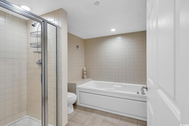 bathroom with tile patterned floors, independent shower and bath, and toilet