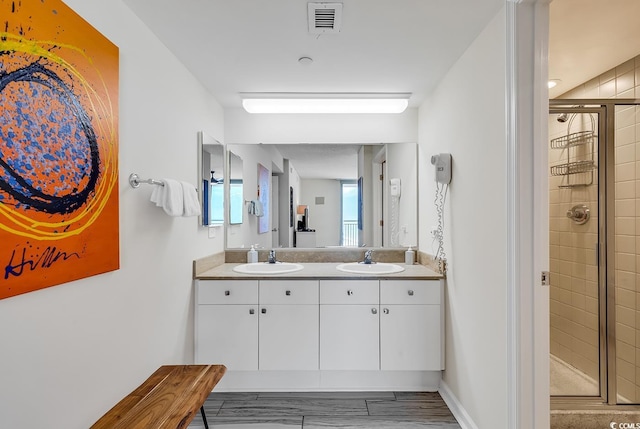 bathroom with vanity and an enclosed shower