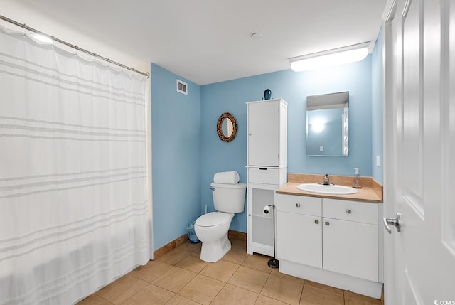 bathroom featuring tile patterned floors, vanity, and toilet