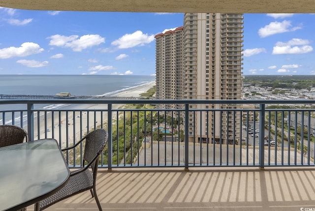 balcony featuring a water view and a beach view