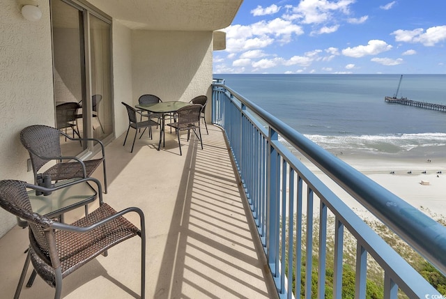 balcony with a view of the beach and a water view