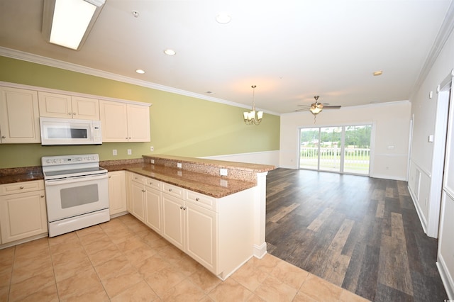 kitchen featuring pendant lighting, white appliances, dark stone countertops, ornamental molding, and kitchen peninsula