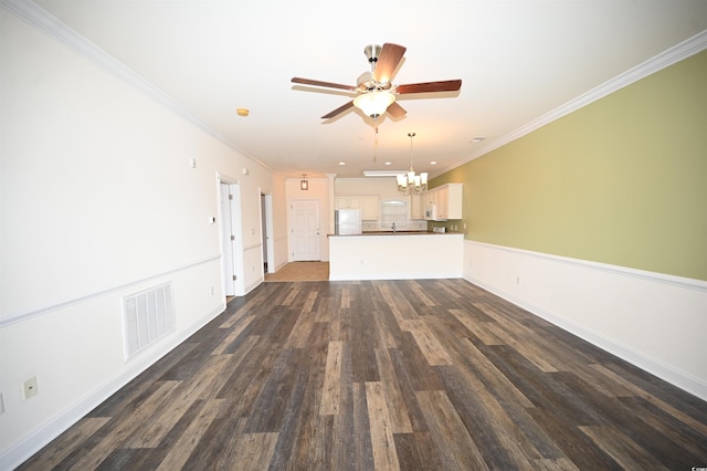 unfurnished living room with crown molding, ceiling fan with notable chandelier, and dark hardwood / wood-style flooring