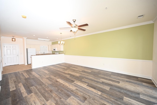 unfurnished living room featuring crown molding, sink, dark wood-type flooring, and ceiling fan with notable chandelier