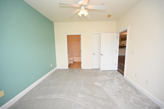 unfurnished bedroom with light carpet, connected bathroom, and ceiling fan