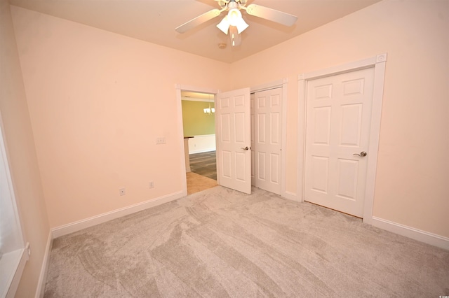 unfurnished bedroom featuring light carpet and ceiling fan