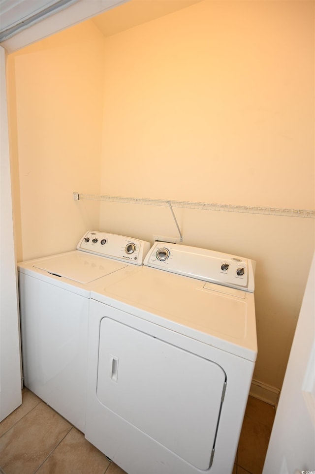 laundry room featuring light tile patterned floors and washing machine and clothes dryer