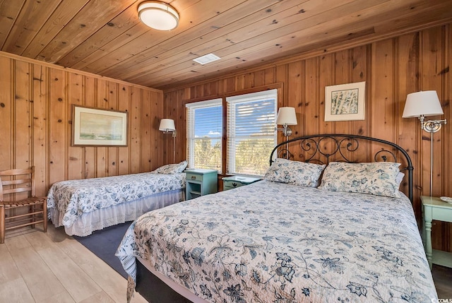 bedroom with wood ceiling and light hardwood / wood-style flooring