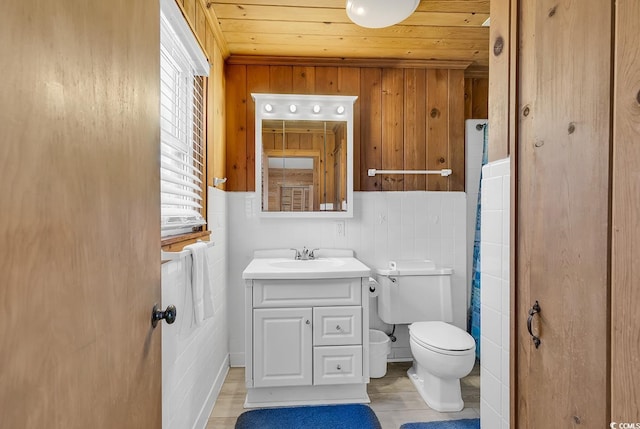 bathroom with toilet, vanity, and wood ceiling