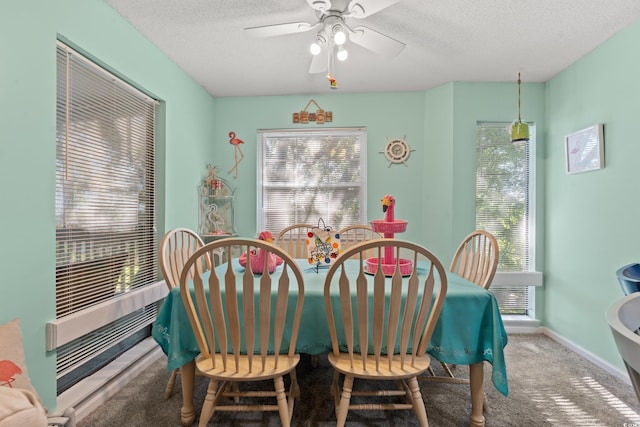 carpeted dining space with ceiling fan and a textured ceiling