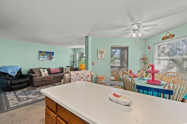 kitchen with light carpet, a textured ceiling, and ceiling fan