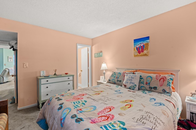 bedroom with carpet and a textured ceiling