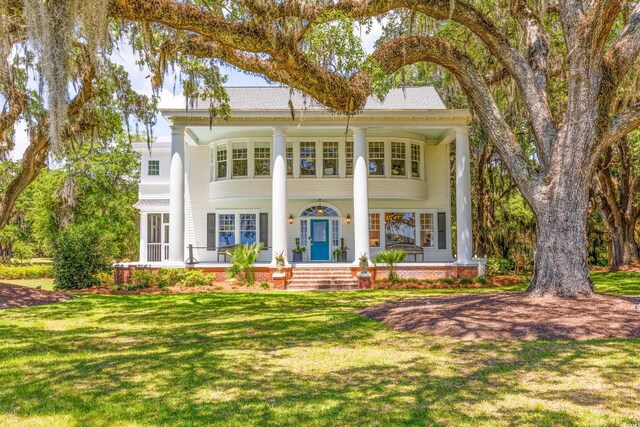 neoclassical home with a front yard