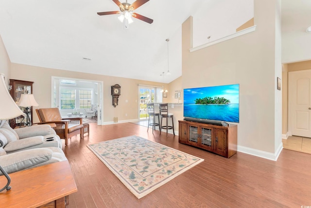 living room featuring a healthy amount of sunlight, hardwood / wood-style flooring, and ceiling fan