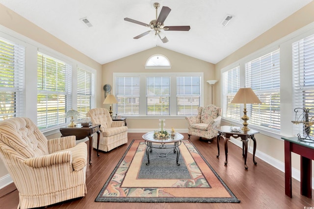 living room featuring lofted ceiling, dark wood-type flooring, and ceiling fan