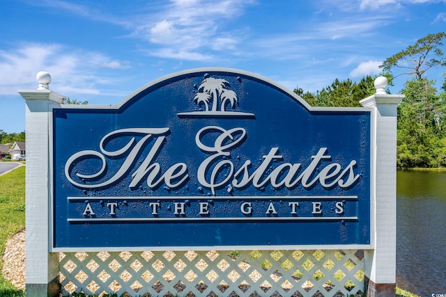 community / neighborhood sign with a water view