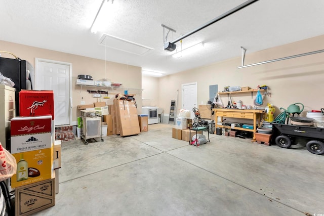 garage featuring washer / dryer and a workshop area