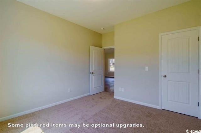 unfurnished bedroom featuring light colored carpet