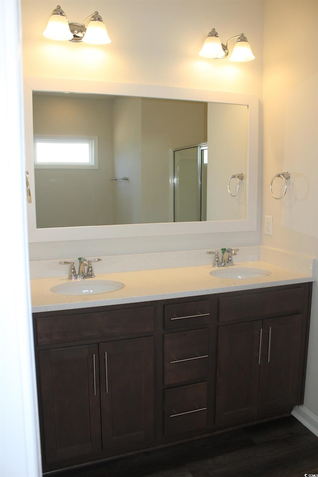 bathroom featuring vanity, an enclosed shower, and hardwood / wood-style floors