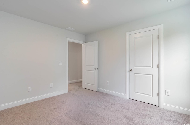 unfurnished bedroom featuring light carpet