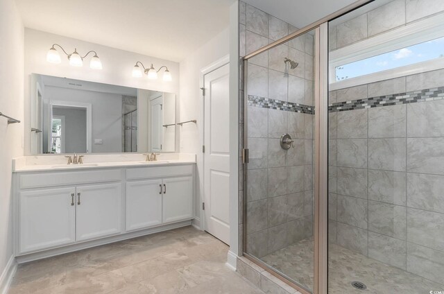 bathroom with vanity and a shower with door