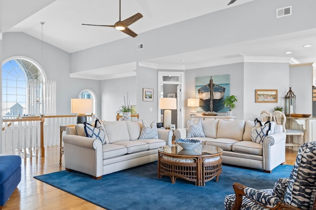 living room featuring ceiling fan, hardwood / wood-style flooring, and vaulted ceiling